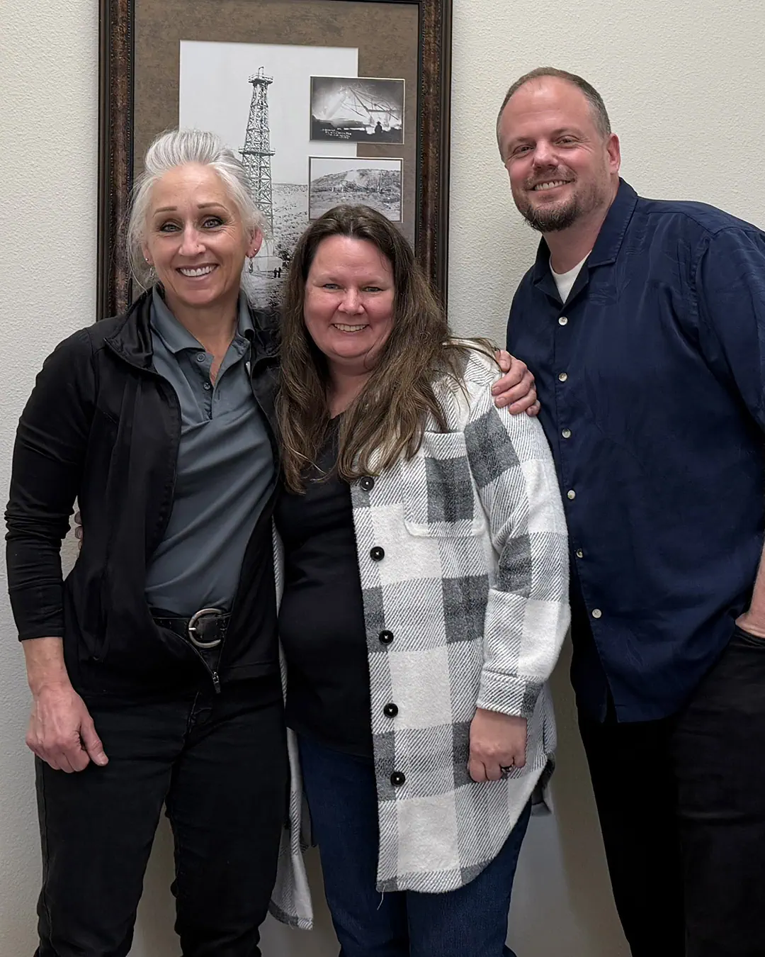 Smiling couple holding their new house keys with Scott Buehler